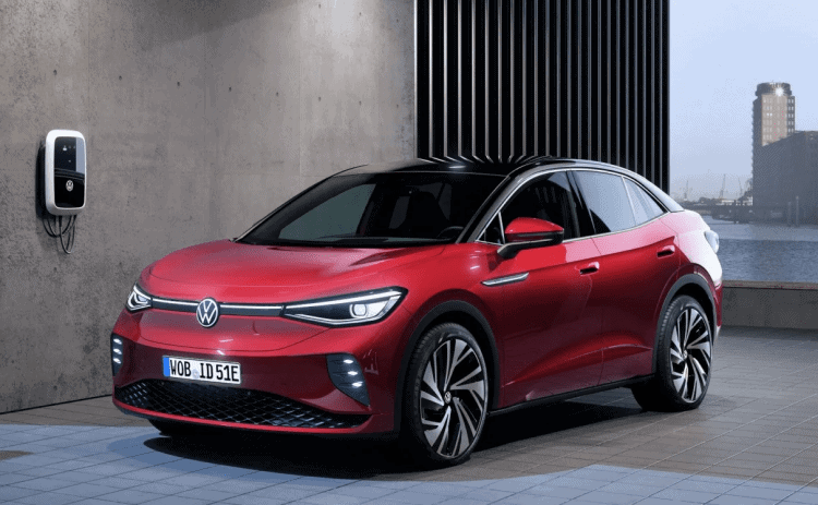 Coche eléctrico Volkswagen ID.5 rojo estacionado en un entorno urbano moderno.