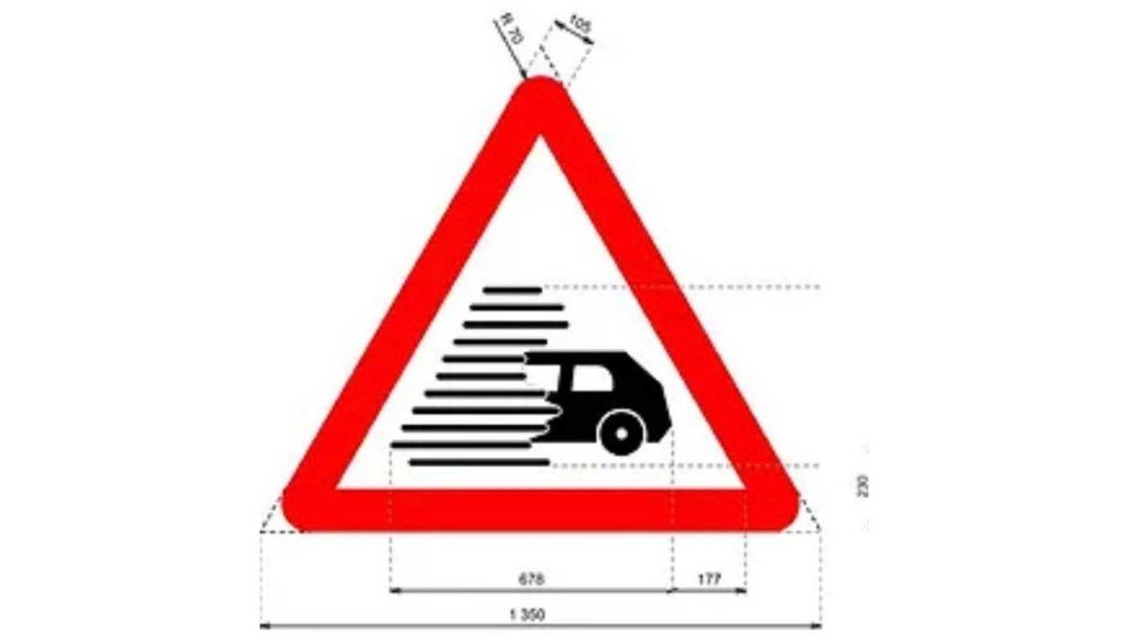 Señal de advertencia de vehículo en movimiento en carretera.