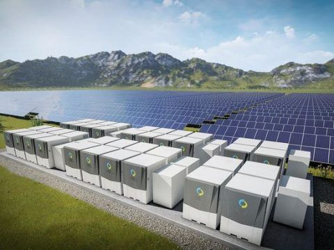 Sistema de almacenamiento de energía solar con baterías en un paisaje montañoso.