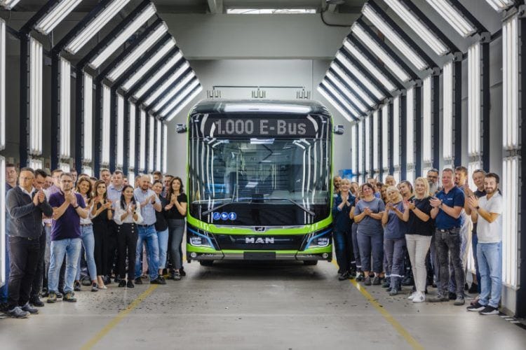 Grupo de personas celebrando la llegada de un autobús eléctrico en un centro de pruebas.