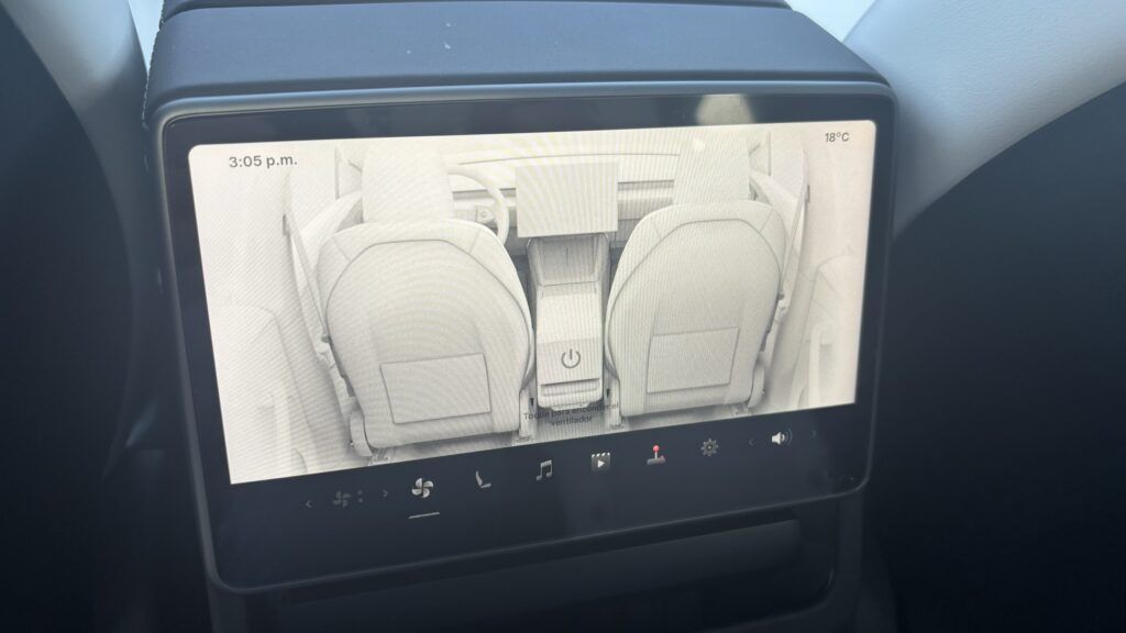 Interior de coche eléctrico con pantalla táctil y asientos modernos.